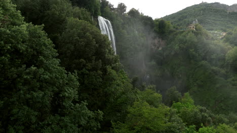 green forest with marmore falls at daytime in umbria, italy