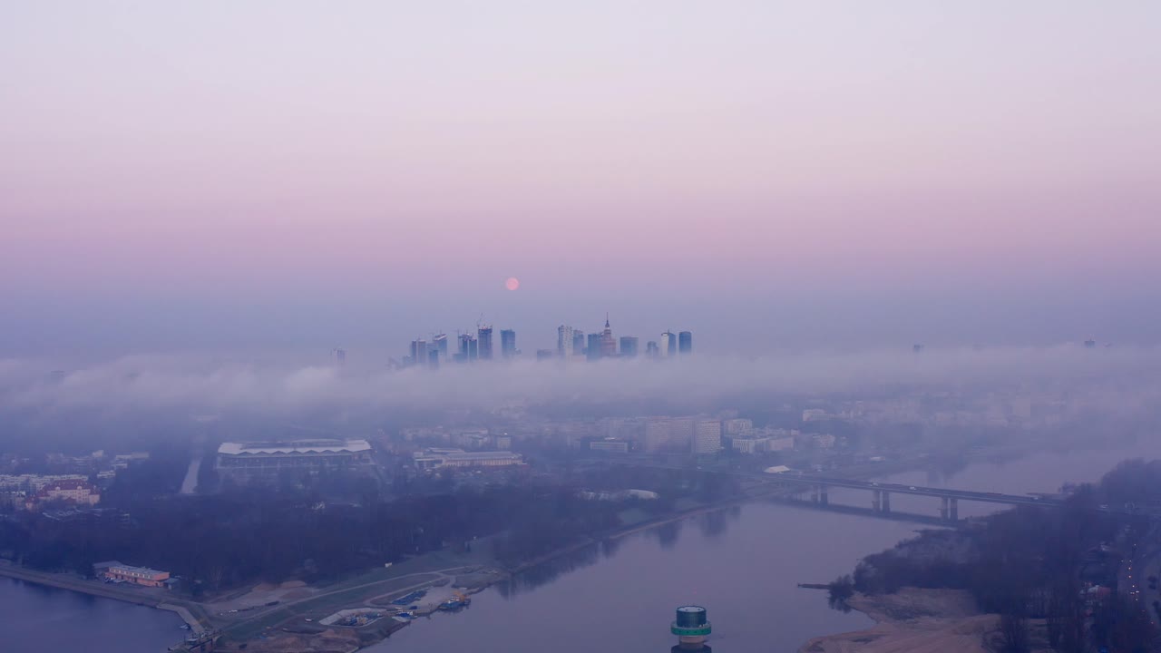 Moon setting during sunrise over Warsaw  from a drone.