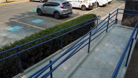 accessible parking ramp with blue handrails