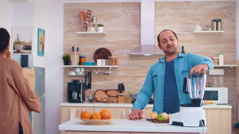 man mixing fruits for smoothie