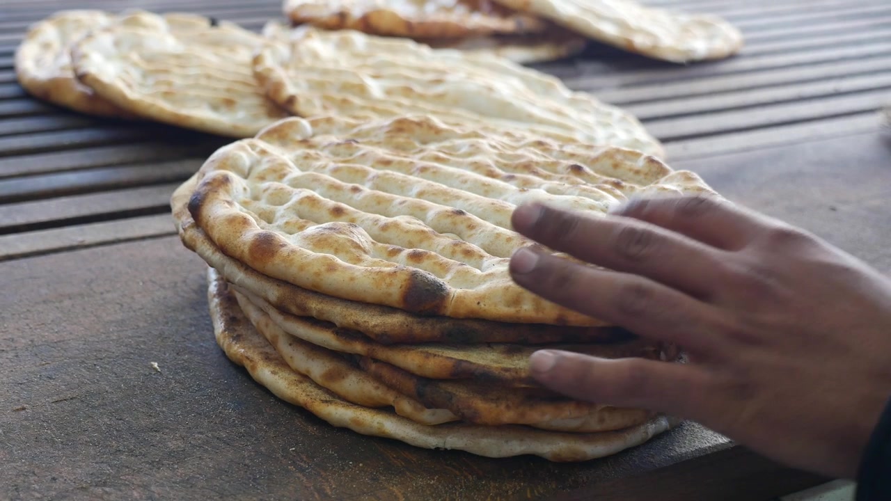 Stack of Freshly Baked Flatbreads on a Wooden Table