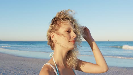 Young-woman-standing-on-a-beach-4k