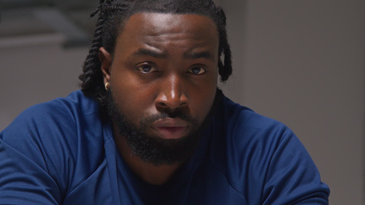Close Up Portrait Of Determined Male Athlete Sport Training In Gym Sitting And Concentrating In Changing Room With Focused Expression 4