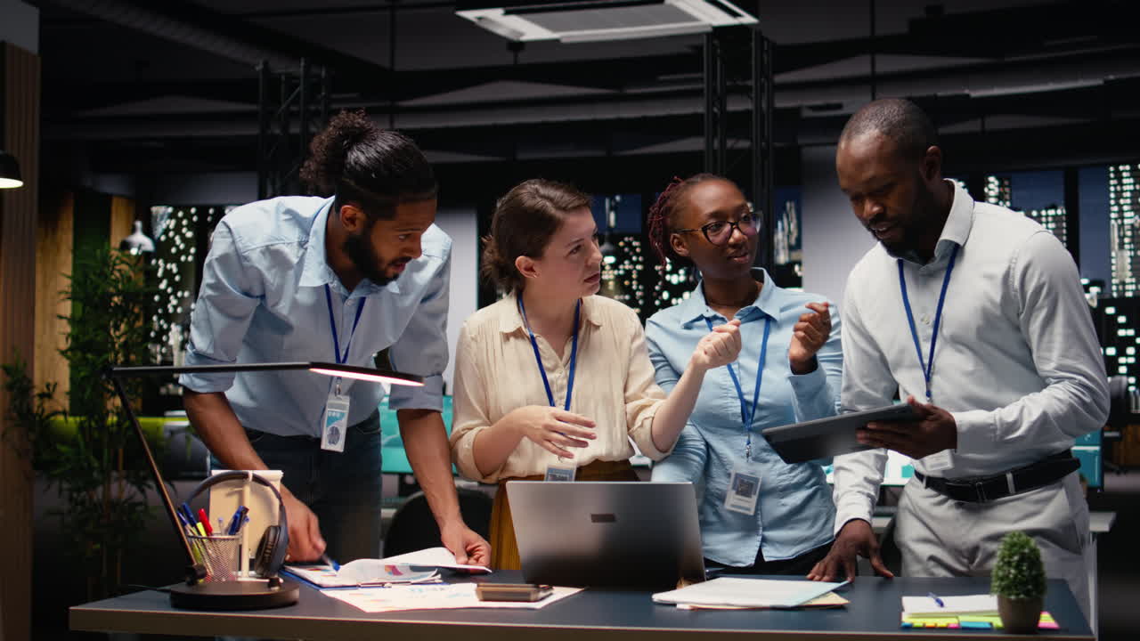 Multiethnic team collaborating in modern office workspace at night