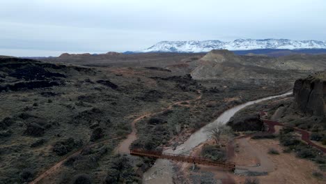 A-hiking-footbridge-over-the-Virgin-River-in-a-Southern-Utah-canyon---static-wide-angle