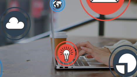 animación de múltiples iconos sobre manos recortadas de una mujer caucásica con café trabajando en una computadora portátil