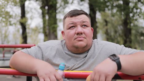 portrait of a depressed fat man on the sports ground the problem of obesity overweight portrait of a depressed fat man on the sports ground the problem of obesity overweight