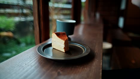 person eating cheesecake at a cafe