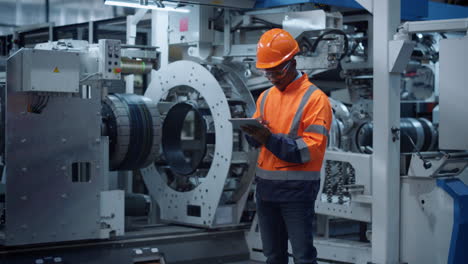 Professional-supervisor-holding-tablet-computer-at-huge-modern-constructions.