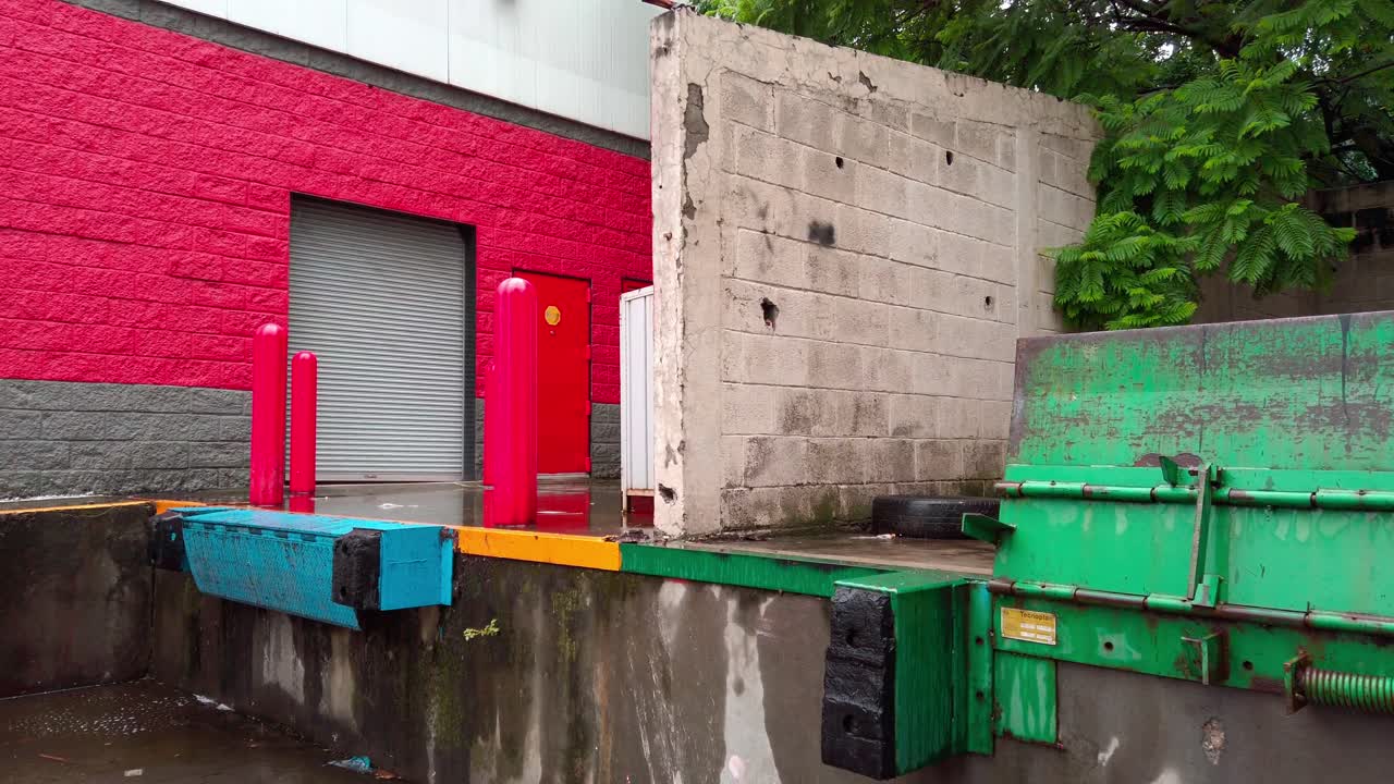 Close-up zoom in on green metal loading dock platform with peeling paint and water stains