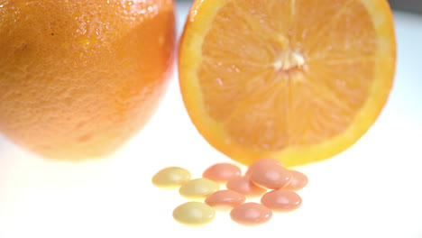 vitamin pills with orange fruit