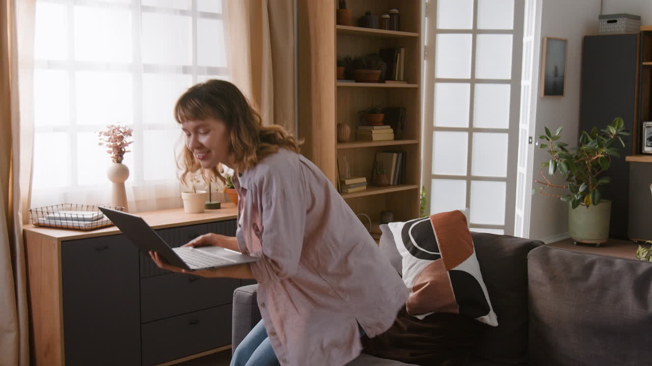 A woman using a laptop at home