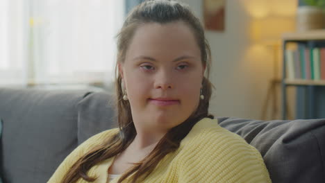 portrait of girl with down syndrome at home