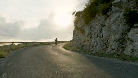 road cycling on mountain pass at sunset