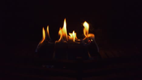 burning log in fireplace. black background. looping