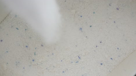 pouring laundry detergent powder
