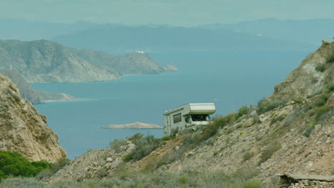 Stunning-shot-of-an-old-campervan-climbing-a-steep-hill-in-Spain