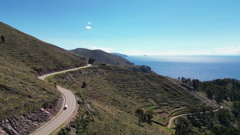 winding highway follows hillside contours above lake titicaca, bolivia