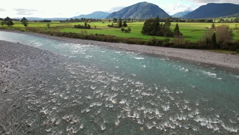 hokitika river and fields in kokatahi, new zealand - drone shot
