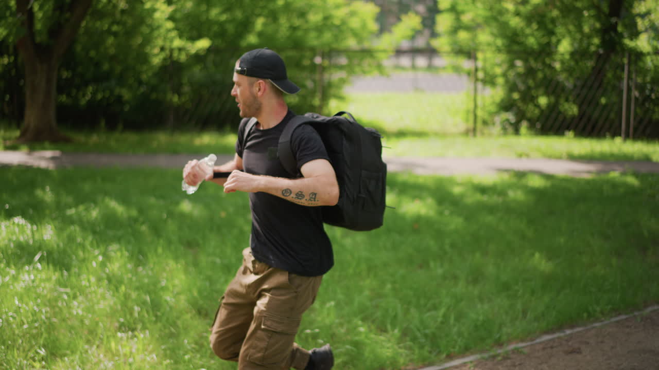 Runner Prepares On Grassy Trail, Person Engages In Vigorous Warmup On Lush Green Track, Athlete Performs Energetic Stretching And Warmup Exercises Before Sprinting On Natural Grassy Surface