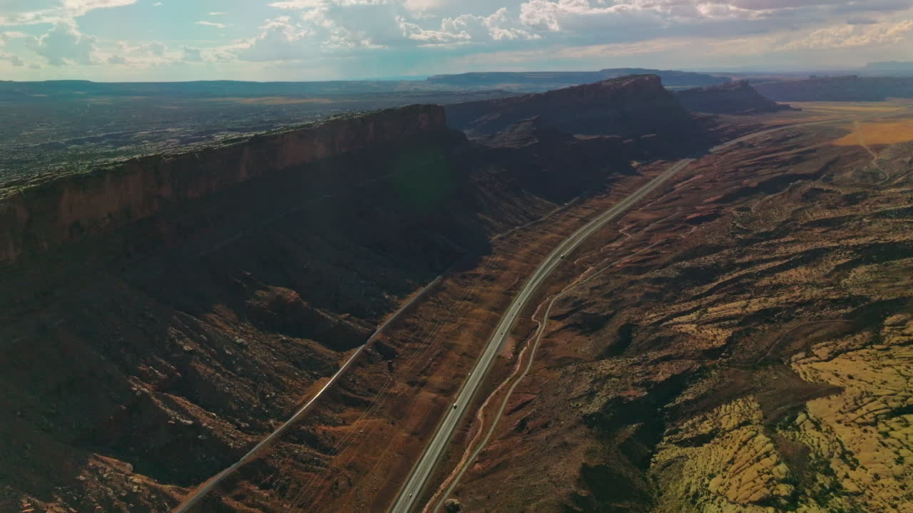 Splendid relief in the Utah National Park. Amazing scenery of rocks and valleys lit by sun from aerial perspective.
