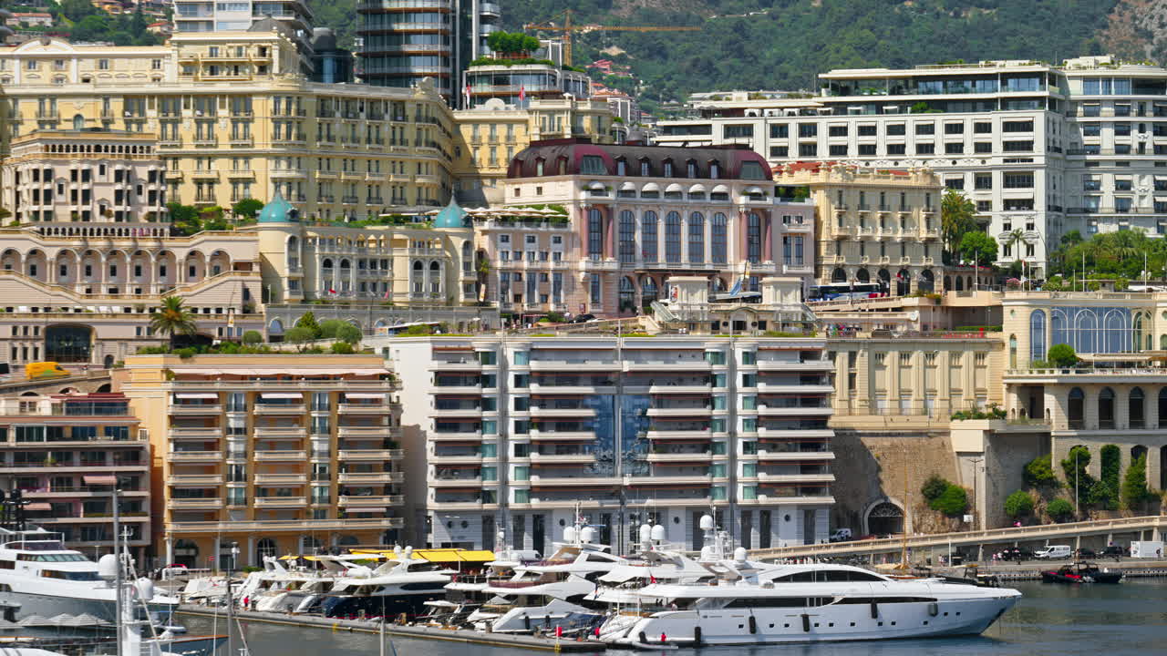 View of boats docked in the Monaco Marina with the skyline of the city on the background