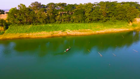 fishing boat on tranquil surma river in bangladesh - aerial shot