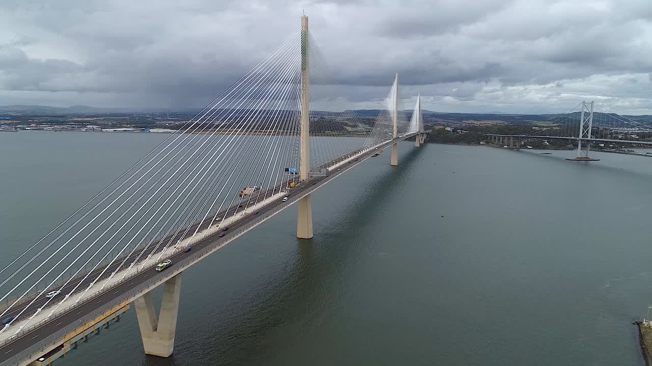 Rising drone footage showing Queensferry Crossing, Scotland on cloudy overcast day.