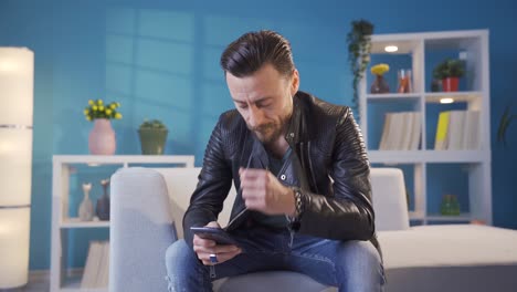 hombre frustrado y frustrado enviando mensajes de texto por teléfono. hombre vestido con estilo.
