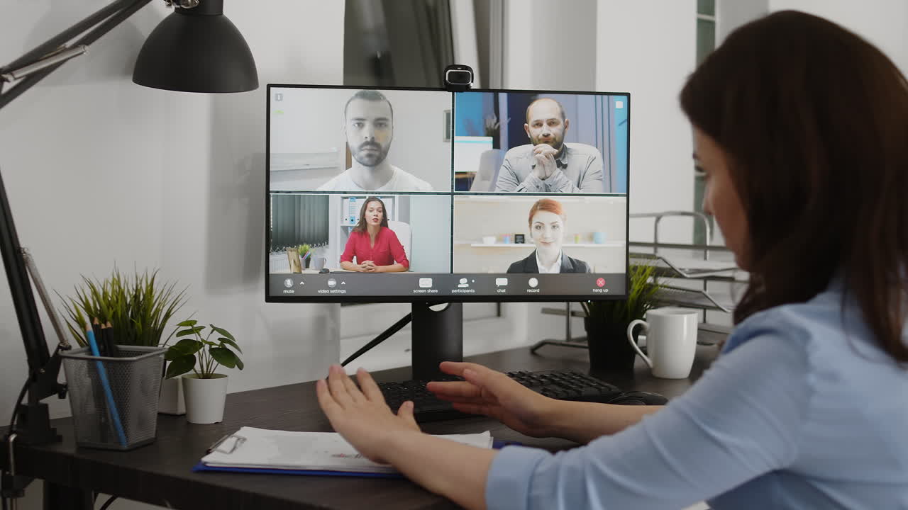 Woman attending a video conference from her home office
