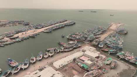 aerial birds eye view of fishing boats moored along jetty at ibrahim hyderi in karachi