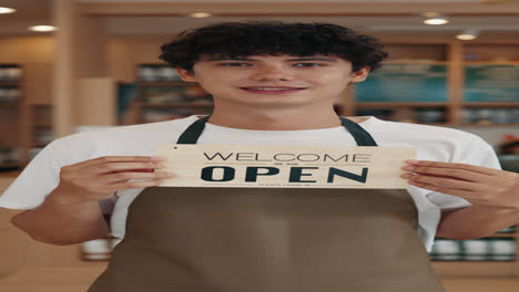 man holding an open sign