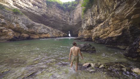 sea cave surrounded by bales of rock.