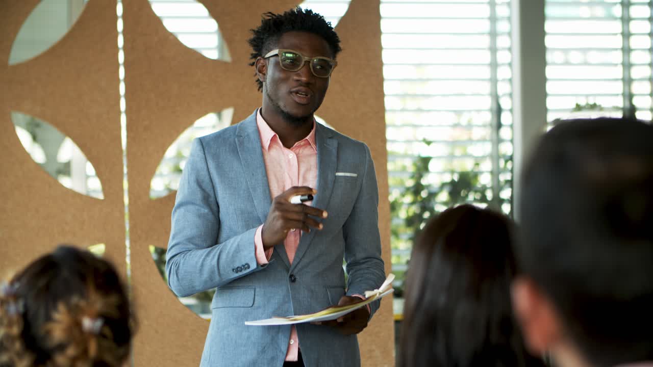 Concentrated business consultant talking with trainees