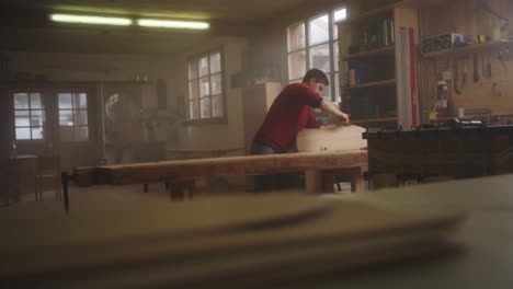 a craftsman files the edge of a wooden board