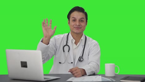 Happy-Indian-doctor-waving-Hi-to-the-camera-Green-screen