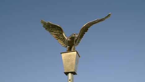 bronze eagle sculpture on a pole