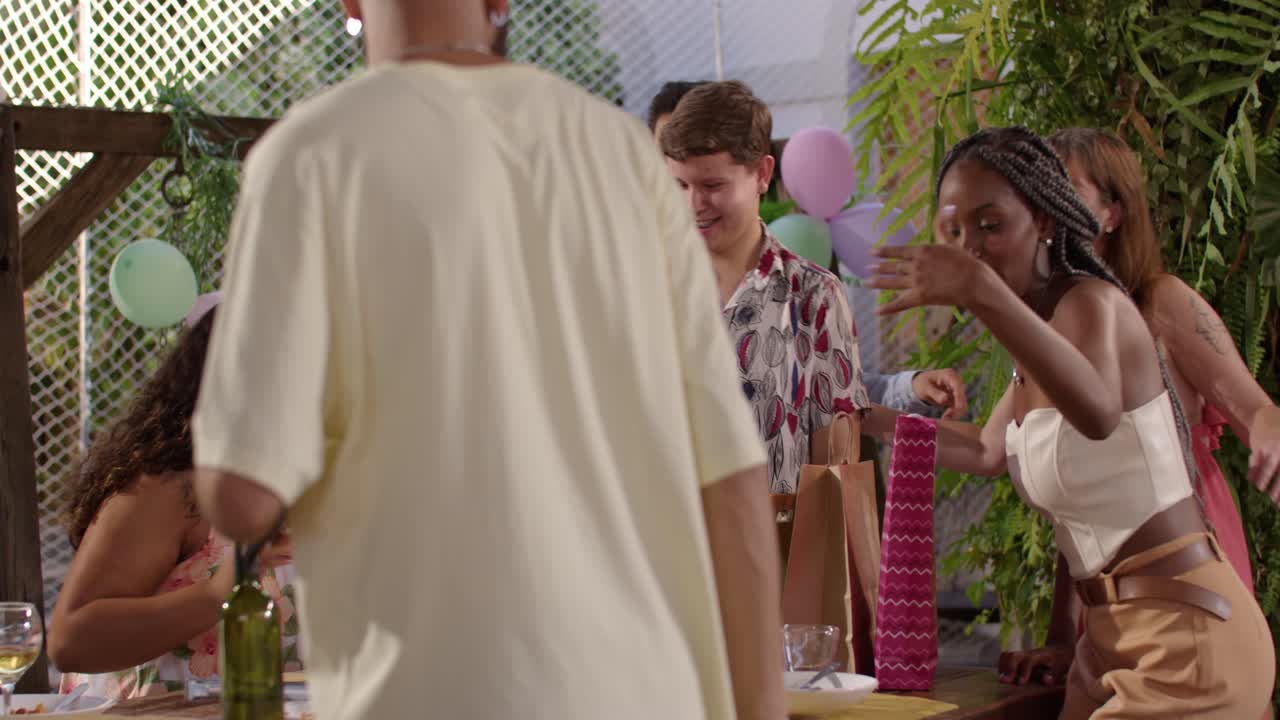 Friends celebrating and taking photos at an outdoor party