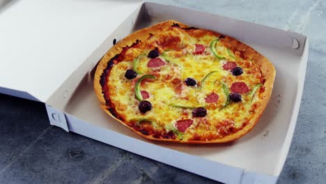 baked pizza with olive and peperoni toppings