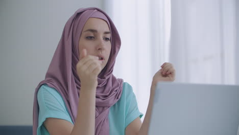 Young-indian-business-woman-wears-hijab-communicates-with-distance-worker-in-webcam-conference-chat.-Muslim-online-teacher-make-video-call-job-interview.