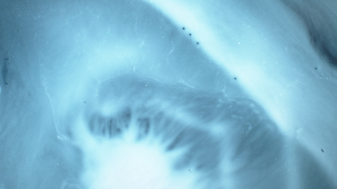 Macro view of swirling substances mixing in abstract pattern