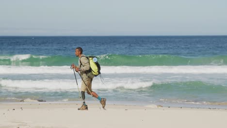 sporty mixed race man with prosthetic leg hiking