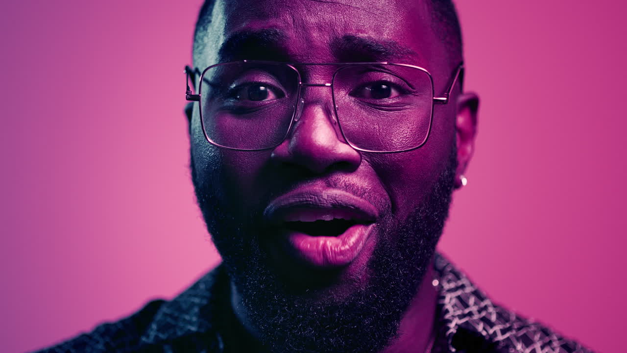 Euphoric afro man saying wow indoors. African male face making surprise