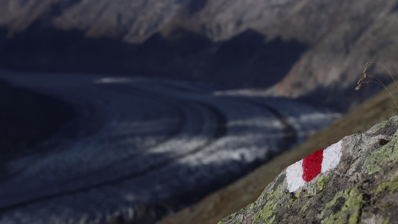 Mountain trail marking with red and white stripes, hard hiking trail sign