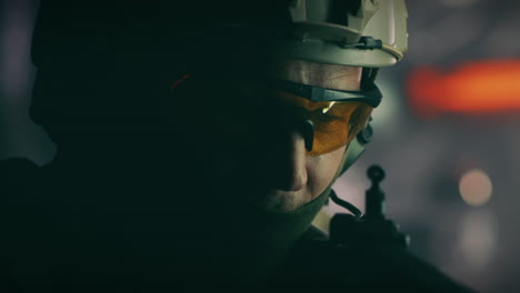 close-up of a soldier in tactical gear with a rifle