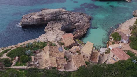 reveal shot of small houses at s'almonia mallorca with no people, aerial