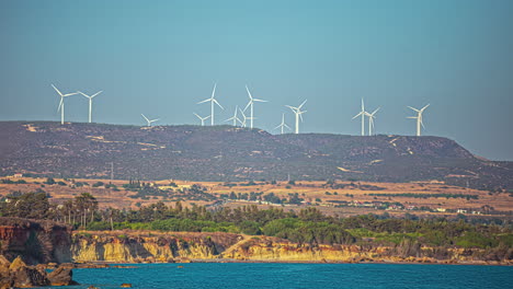 Timelapse-shot-of-offshore-wind-turbines-along-the-sea-shore-on-a-sunny-day