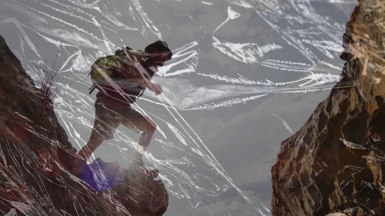 hiker stepping across rocky canyon in tech demo, showing scratched film overlay and backpack label