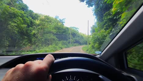 pov: driving a car on a rural jungle road in koh chang island, thailand, asia