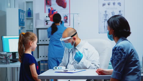 Doctor-examining-girl-by-stethoscope